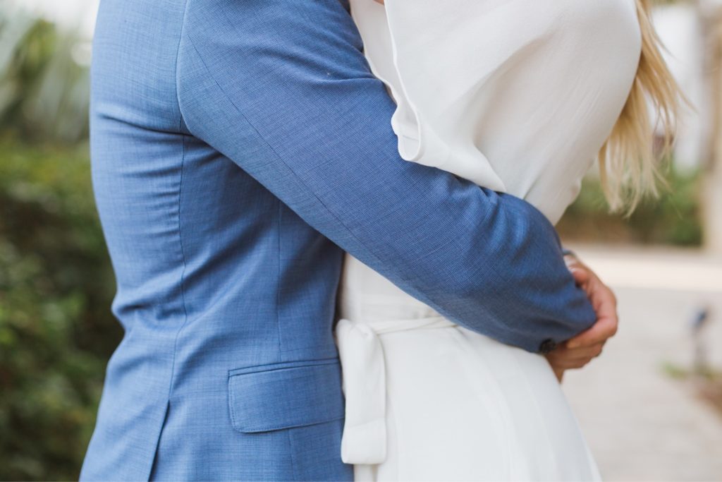 groom holding bride's waist