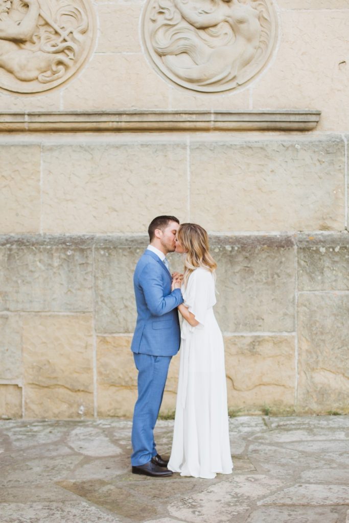kissing photo in front of brick wall