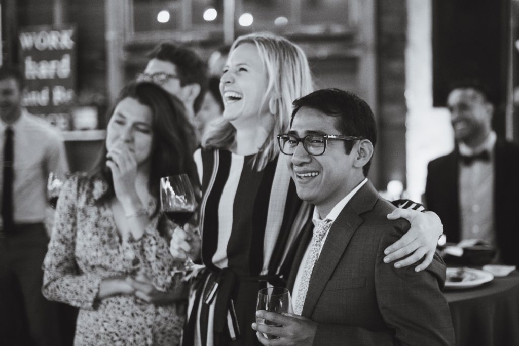 guests laughing at narrative loft wedding reception
