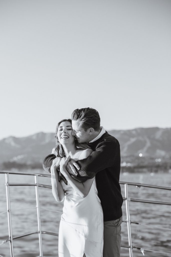 couple taking engagement photos on sailboat