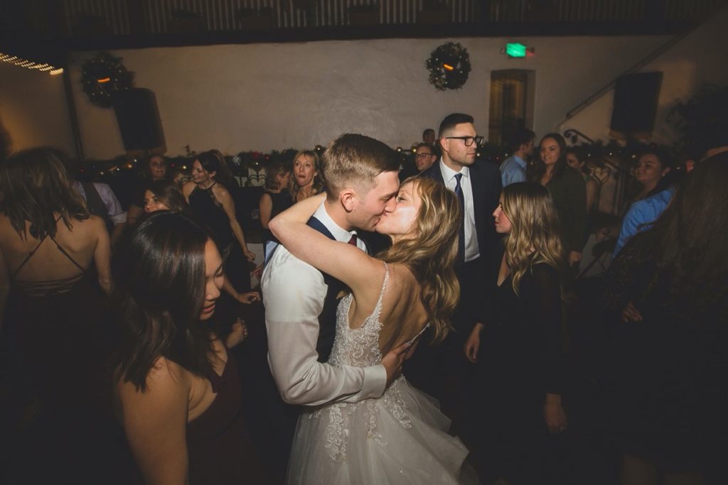 bride and groom kiss dance floor