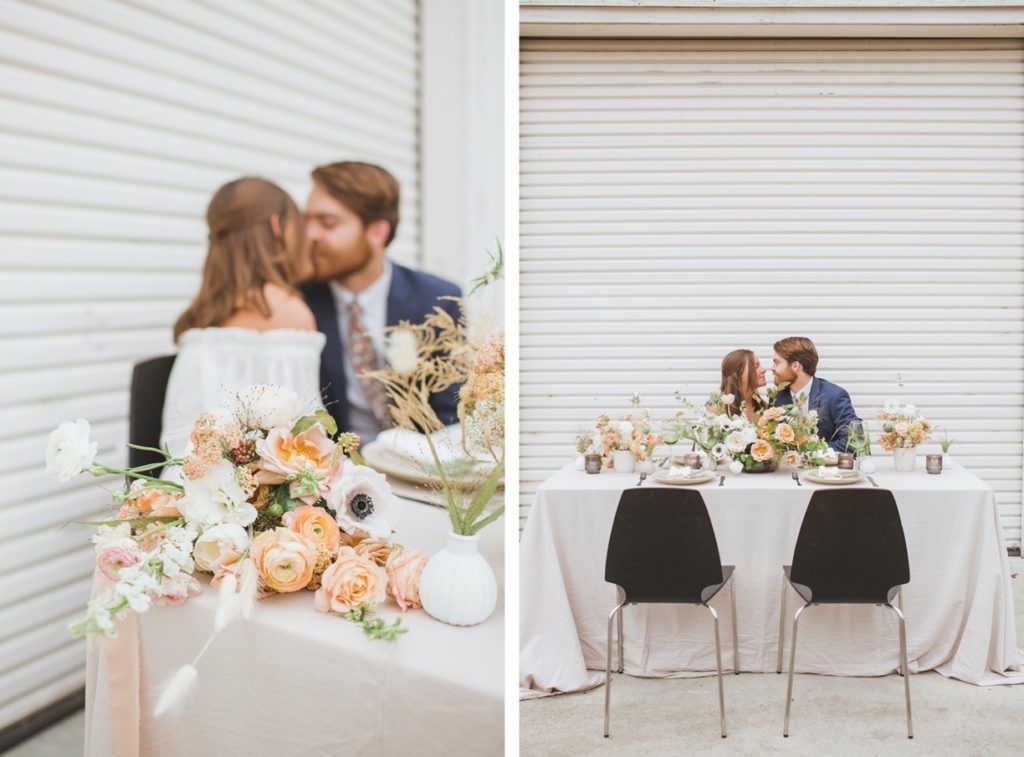 bride and groom kissing at wedding table