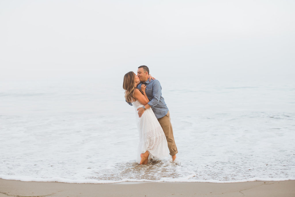 couple kissing in the waves