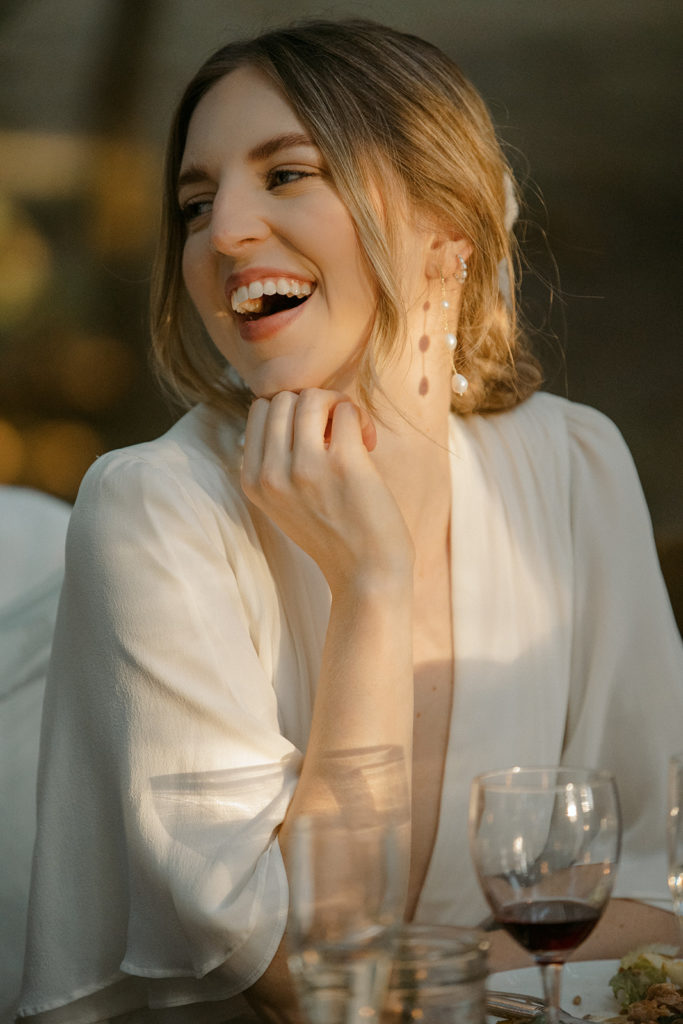 bride laughing at dinner