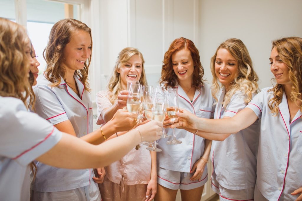 bridesmaids doing cheers with champagne