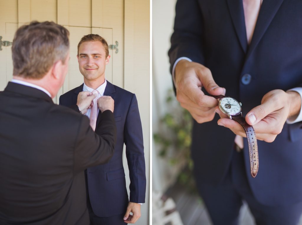 groom's father adjusting tie and groom with watch