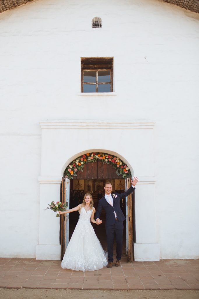 bride and groom exiting el presidio chapel