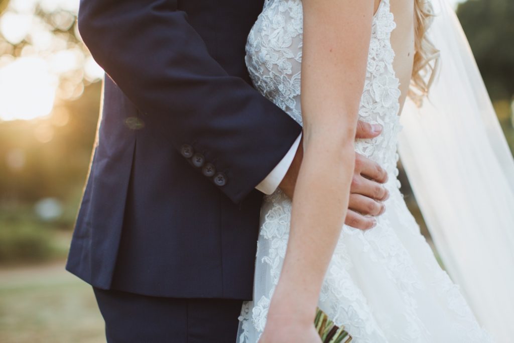 groom's hands on bride's waist